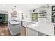 Bright kitchen features white cabinetry, quartz countertops, stainless appliances, and an island with pendant lighting at 4431 Cranbrook Dr, Indianapolis, IN 46250