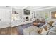 Cozy living room with a fireplace, hardwood floors, and white built-in shelving at 4431 Cranbrook Dr, Indianapolis, IN 46250