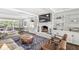Bright living room featuring a brick fireplace with built-ins and hardwood floors at 4431 Cranbrook Dr, Indianapolis, IN 46250