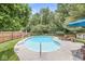 Backyard pool with a diving board, basketball hoop, deck chairs, and a wooden privacy fence offers a serene escape at 4431 Cranbrook Dr, Indianapolis, IN 46250