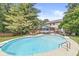 An expansive outdoor pool features a diving board and multiple seating areas including lounge chairs and a patio dining set at 4431 Cranbrook Dr, Indianapolis, IN 46250