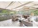 Inviting sunroom with tile floors, comfortable seating, and large windows offering views of the outdoors at 4431 Cranbrook Dr, Indianapolis, IN 46250