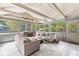 Bright sunroom featuring tile floors, neutral furniture, and multiple windows that fill the space with sunlight at 4431 Cranbrook Dr, Indianapolis, IN 46250