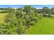 Tranquil aerial shot showcasing a lush green field and a pond surrounded by dense trees at 4535 N Us Hwy 52, Thorntown, IN 46071