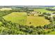 A panoramic view of green farmland with a metal building and lush trees at 4535 N Us Hwy 52, Thorntown, IN 46071
