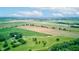 Aerial view capturing expansive farmland, distant houses, and the verdant surrounding scenery at 4535 N Us Hwy 52, Thorntown, IN 46071