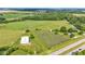 Aerial view of green pastures and a white metal building at 4535 N Us Hwy 52, Thorntown, IN 46071