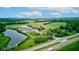 Scenic aerial view highlights the golf course, pond, and highway in a picturesque landscape at 4535 N Us Hwy 52, Thorntown, IN 46071