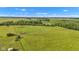 Wide aerial view of a lush green field with cows grazing, farmland and blue sky at 4535 N Us Hwy 52, Thorntown, IN 46071