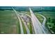 Aerial view featuring a highway, farmland, and a commercial area with ample parking at 4535 N Us Hwy 52, Thorntown, IN 46071