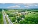 An aerial shot highlights the landscape, featuring a serene pond and golf course at 4535 N Us Hwy 52, Thorntown, IN 46071