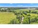 Expansive aerial view featuring green pastures, lush trees, and a tranquil flowing stream at 4535 N Us Hwy 52, Thorntown, IN 46071