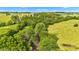 Scenic aerial view showcasing a creek flowing through a verdant landscape with lush trees and fields at 4535 N Us Hwy 52, Thorntown, IN 46071
