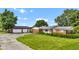 Quaint brick home with a detached garage, surrounded by green lawns and mature trees at 4535 N Us Hwy 52, Thorntown, IN 46071