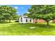 Charming outdoor space showcasing the lawn and a small white outbuilding at 4535 N Us Hwy 52, Thorntown, IN 46071