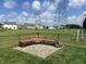 Beautiful backyard with a bench and wood, framed by a dark metal fence at 4726 Deacon Ln, Indianapolis, IN 46237
