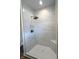 Tiled shower with white marble-style large tiles, a bronze shower head, and a built-in seat at 4726 Deacon Ln, Indianapolis, IN 46237