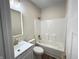 Bathroom with modern gold hardware, a shower-tub combination, and wood-look flooring at 4726 Deacon Ln, Indianapolis, IN 46237