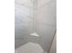Corner view of a tiled shower with a marble-style and a built-in corner seat at 4726 Deacon Ln, Indianapolis, IN 46237