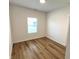 Bedroom features wood-look vinyl flooring, natural light and neutral paint at 4726 Deacon Ln, Indianapolis, IN 46237