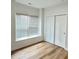 Bedroom with modern vinyl floors, a large window, and a closet with sliding doors at 4726 Deacon Ln, Indianapolis, IN 46237