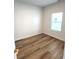 Bright bedroom with wood-look flooring and a sunlit window at 4726 Deacon Ln, Indianapolis, IN 46237