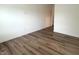 A naturally lit bedroom with wood-look vinyl floors and white walls at 4726 Deacon Ln, Indianapolis, IN 46237