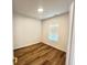 Bright bedroom featuring hard surface flooring, a window, and neutral paint at 4726 Deacon Ln, Indianapolis, IN 46237