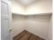 Walk-in closet featuring wood-look vinyl floors and a rod for hanging clothing at 4726 Deacon Ln, Indianapolis, IN 46237