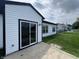 Exterior view of the home with a sliding glass door and a concrete patio at 4726 Deacon Ln, Indianapolis, IN 46237