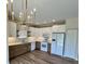 Modern kitchen with sleek appliances, hardwood floors, and stylish white and wood cabinetry at 4726 Deacon Ln, Indianapolis, IN 46237