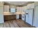 Bright kitchen featuring stainless steel appliances, hardwood floors, and modern white cabinetry at 4726 Deacon Ln, Indianapolis, IN 46237