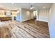 Open-concept living room featuring hardwood floors, with a view into the modern kitchen at 4726 Deacon Ln, Indianapolis, IN 46237