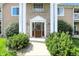 Close-up of the building entrance with well-manicured shrubbery and a paved path at 5003 Opal Ridge Ln # 101, Indianapolis, IN 46237