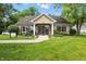 The clubhouse features welcoming landscaping, a cozy front bench, and plenty of natural light at 5003 Opal Ridge Ln # 101, Indianapolis, IN 46237
