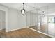 Dining area with mirrored wall, modern lighting fixture, and hardwood flooring at 5003 Opal Ridge Ln # 101, Indianapolis, IN 46237