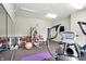 Community gym features a weight machine, elliptical, and mirrored wall for exercise and motivation at 5003 Opal Ridge Ln # 101, Indianapolis, IN 46237