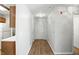 Hallway featuring wood flooring and neutral walls leading to various rooms in the house at 5003 Opal Ridge Ln # 101, Indianapolis, IN 46237