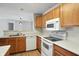 Kitchen with laminate countertops and matching appliances open to the dining area at 5003 Opal Ridge Ln # 101, Indianapolis, IN 46237