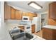 Functional kitchen featuring classic oak cabinets and white appliances at 5003 Opal Ridge Ln # 101, Indianapolis, IN 46237