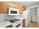Bright kitchen with white appliances and laminate countertops near laundry appliances at 5003 Opal Ridge Ln # 101, Indianapolis, IN 46237
