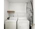 Bright laundry room features a washer, dryer, and storage shelf for detergents and other supplies at 5003 Opal Ridge Ln # 101, Indianapolis, IN 46237