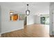 Open-concept living space with hardwood floors and a modern pendant light at 5003 Opal Ridge Ln # 101, Indianapolis, IN 46237