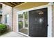 A view of a sliding glass door with neutral siding and brick, as well as lush foliage, enhance curb appeal at 5003 Opal Ridge Ln # 101, Indianapolis, IN 46237