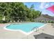 Sparkling community swimming pool with lounge chairs and a surrounding fence for a relaxing and secure experience at 5003 Opal Ridge Ln # 101, Indianapolis, IN 46237
