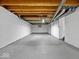 Spacious unfinished basement with concrete floor and exposed ceiling beams offers ample room for customization at 528 W Mechanic St, Shelbyville, IN 46176