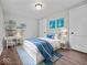 This bedroom features stylish decor, including wall art and a cozy bed, creating a charming and inviting space at 528 W Mechanic St, Shelbyville, IN 46176