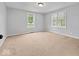 Bright bedroom with neutral carpeting, large windows offering plenty of natural light and a serene atmosphere at 528 W Mechanic St, Shelbyville, IN 46176
