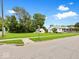 Quaint white home with blue porch, lush front lawn, and street view creating a welcoming curb appeal at 528 W Mechanic St, Shelbyville, IN 46176