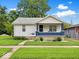 Charming single-story home with white siding, blue porch, and well-maintained lawn at 528 W Mechanic St, Shelbyville, IN 46176
